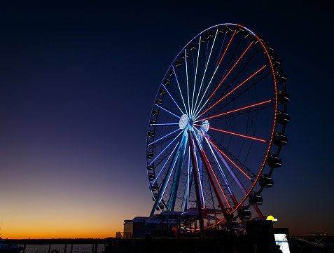 ferris wheel lit up red, white and blue