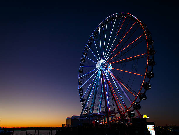 ferris wheel lit up red, white and blue ferris wheel lit up red, white and blue national landmark stock pictures, royalty-free photos & images