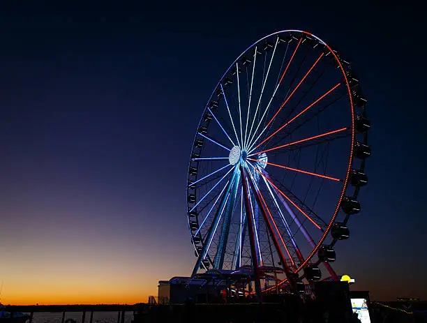 Photo of ferris wheel lit up red, white and blue