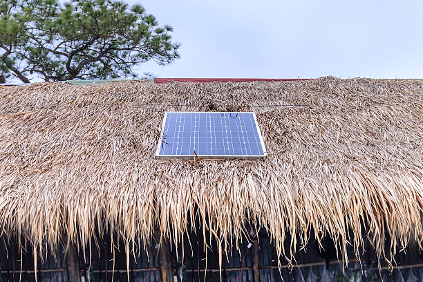 istock Solar cell on thatched roof for energy in forest. 504251308