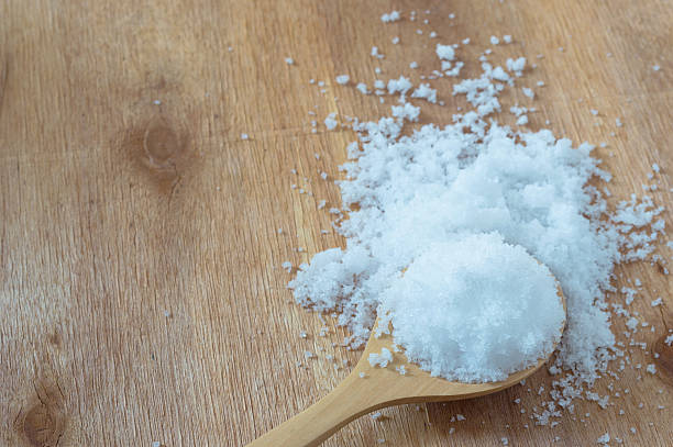 istock white sugar in wood spoon on wood background 504252178