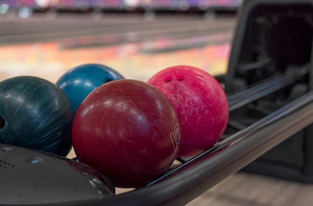 istock different colored bowling balls on returner at alley 504252286
