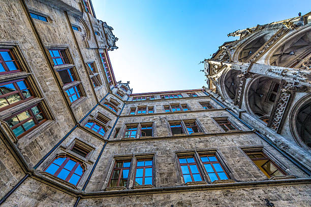 Marienplatz, Munich - The New City Hall. In the Middle Ages markets and tournaments were held in this city square. Marienplatz was named after the Mariensäule, a Marian column erected in its centre in 1638 to celebrate the end of Swedish occupation. Today the Marienplatz is dominated by the New City Hall on the north side. The Glockenspiel in the tower of the new city hall was inspired by these tournaments, and draws millions of tourists a year. At the east side Munich's Old City Hall is located. It's a gothic council hall and ballroom and tower, which have been reconstructed.