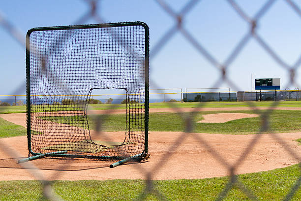 istock Baseball Field by the Pacific Ocean with a practice net 504253592