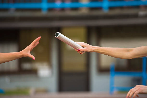 istock Close-up of Two Female Athletes at Relay Passing 504263353