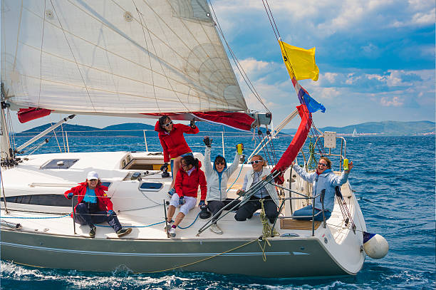 Side view of sailboat, all women team celebrating