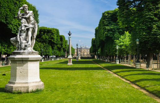 Statues, columns , lampposts and manicured grounds of the Luxembourg Gardens, the second largest public park in Paris,France. The park is the garden of the French Senate, which is itself housed in the Luxembourg Palace in the background.