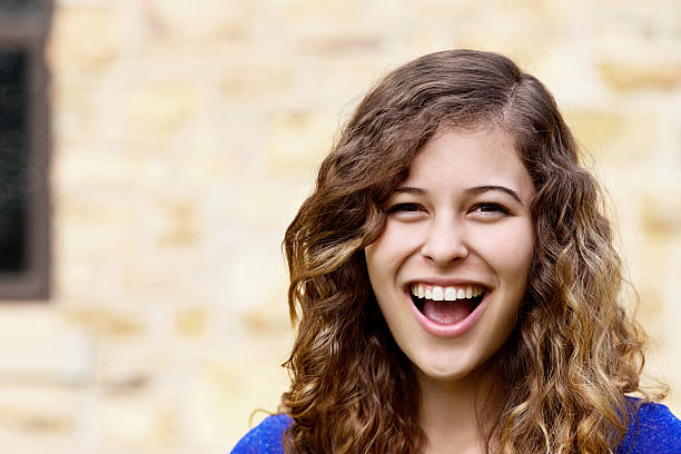 istock Laughing young beauty with curly hair 504264437