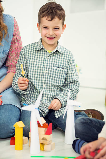 istock Little boy making power windmills in a kindergarden. 504264533