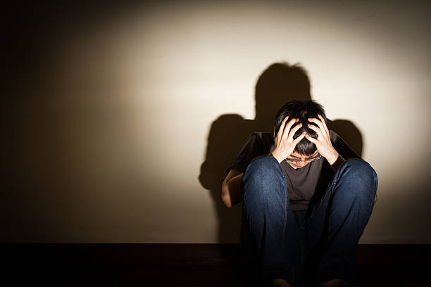 istock depressed despaired young man sit on the floor 504270672