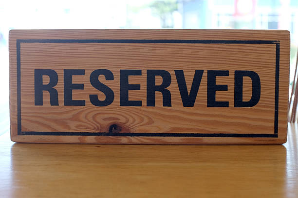 istock Reserved wooden sign on table 504271040