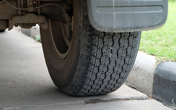 istock wheel car near a footpath in black and white. 504273468
