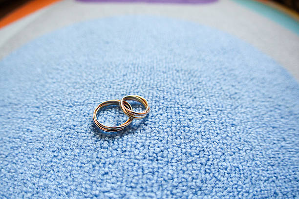istock wedding rings on a blue carpet 504276250