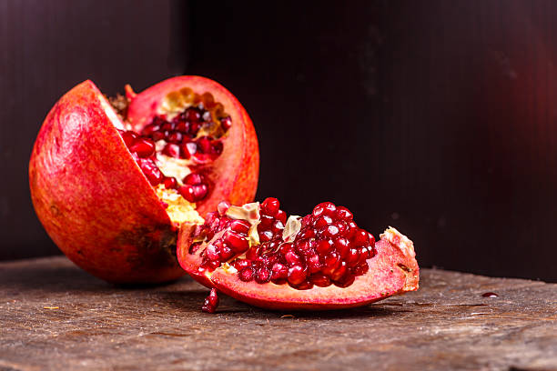 istock Pomegranate fruit lies on the dark Board 504276254