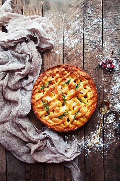 Apple pie on vintage wooden background texture.