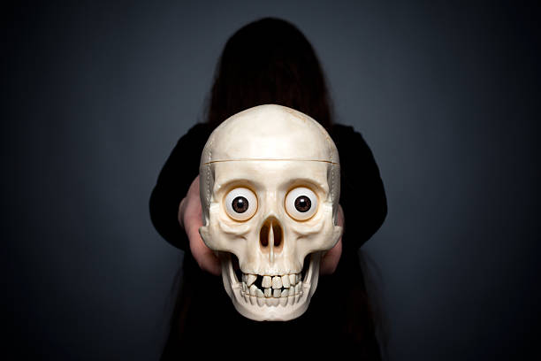 istock the witch holds a skull in hand 504277102