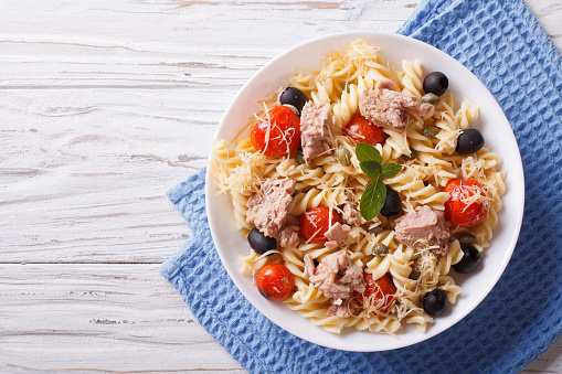 fusilli pasta with tuna, tomatoes and parmesan. horizontal top v