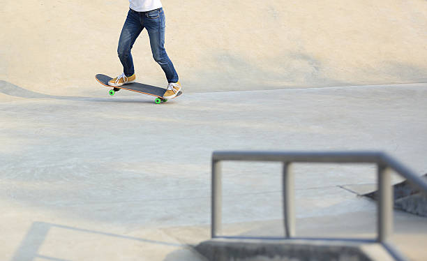 istock skateboarding legs at skatepark 504278182