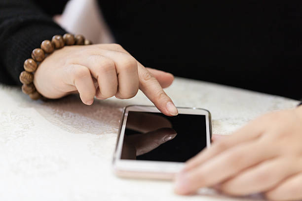 istock Asian woman's hands with smartphone 504279148