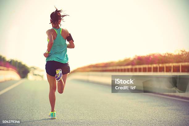 Young Woman Runner Running On City Bridge Road Stock Photo - Download Image Now - Active Lifestyle, Adult, Adults Only