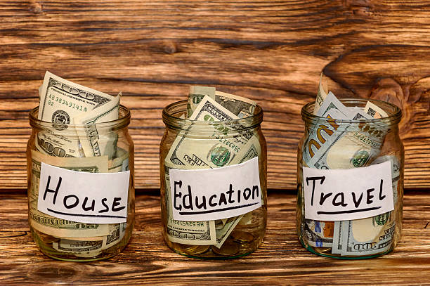 istock Saving dollars into glass jar for future investment 504279858