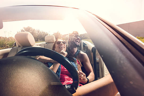 istock Young cheerful couple relaxing in cabriolet and laughing. 504280472