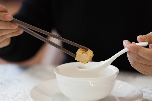 Hand Holding Chopsticks On White Background