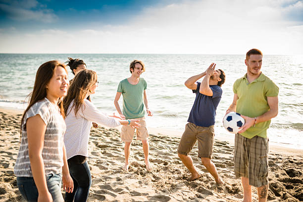 istock friends playing volleyball on the beach 504281896