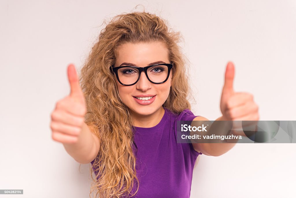 Woman with jeans Portrait of a girl in glasses showing thumbs raised up Adult Stock Photo