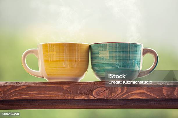 Mugs With A Hot Drink With Tea On A Wooden Stock Photo - Download Image Now - Pair, Mug, Coffee Cup