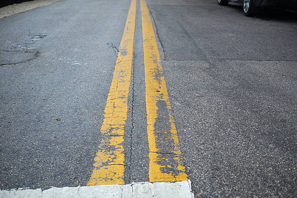 istock Close-Up To Asphalt Road With Yellow Lines 504283512