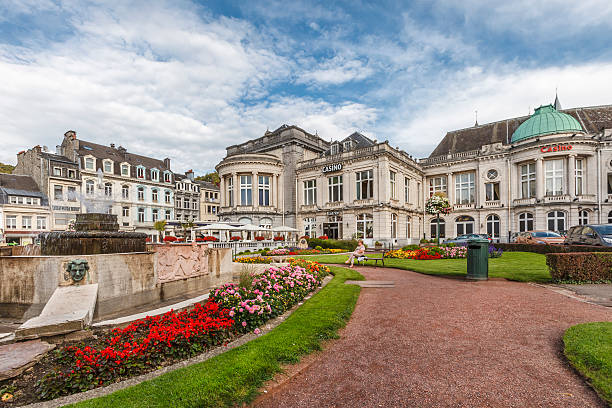 Spa - Casino, Belgium Spa, Belgium - September 19, 2014: People rest in the flowered garden in front of the casino of Spa, one of the landmarks of the city. The construction of the historic building started in 1763 by the prince-bishop of Liege. spa belgium stock pictures, royalty-free photos & images