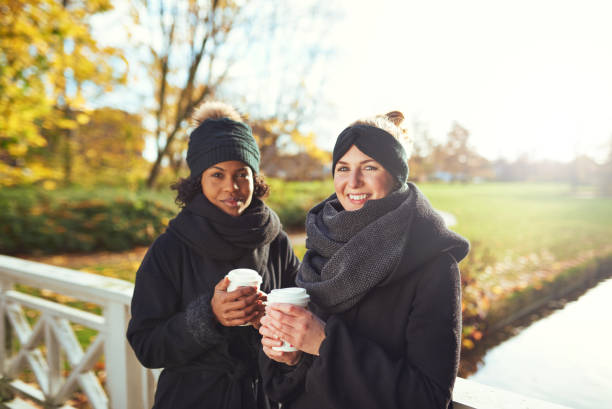 istock Two attractive women chatting in a winter park 504284232
