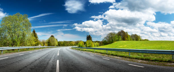 Road panorama on sunny spring day asphalt road panorama in countryside on sunny spring day road panoramic scenics journey stock pictures, royalty-free photos & images