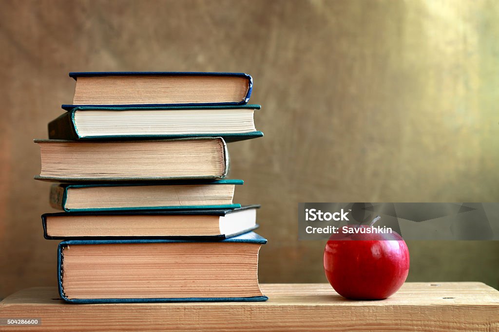 Books and apple Books and an apple on the table. Apple - Fruit Stock Photo