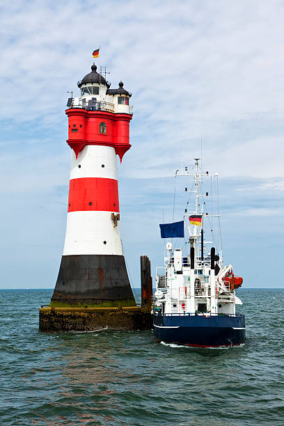 istock Supply ship at Roter Sand lighthouse 504286763