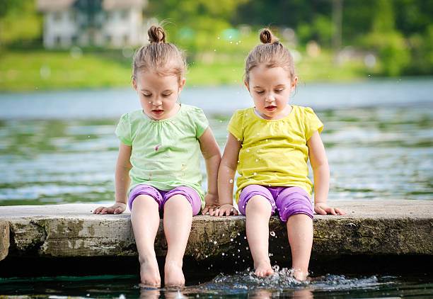 istock Twin girls exercising on a lake shore 504287824