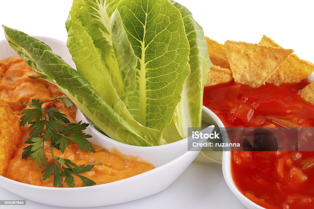 Nachos, cheese and red sauce,  vegetables Nachos,  cheese and red sauce, vegetables isolated on white background. Appetizer Stock Photo