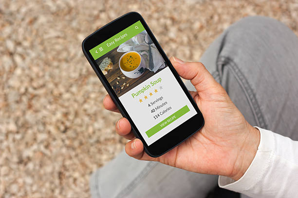 istock Hand holding smartphone with food application mock up on screen. 504288098