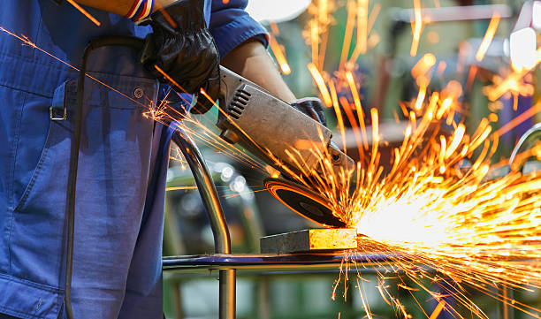 istock worker grinding steel by electric grinding machine 504288169