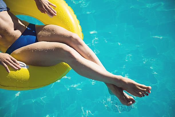 Young woman enjoying a swimming pool stock photo