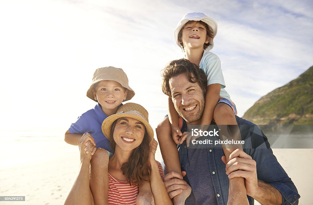 Happy as can be Cropped portrait of a happy young family on the beach Adult Stock Photo