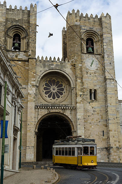 Lisbon cathedral and a yellow tramway stock photo