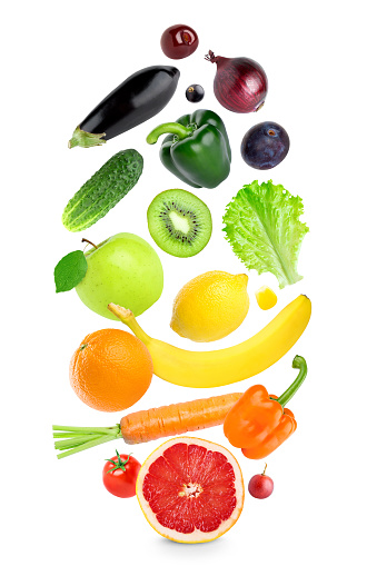 Falling fresh color fruits and vegetables on white background