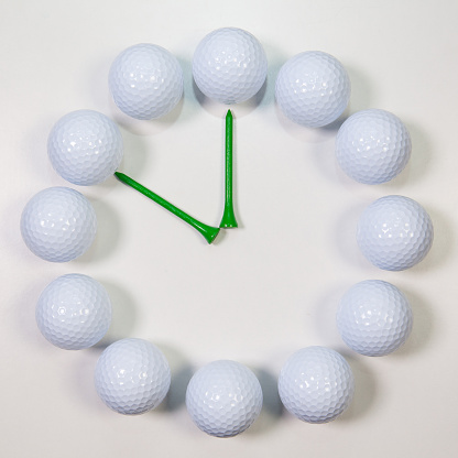 Golf Time -  The clock of golf balls and wooden tees