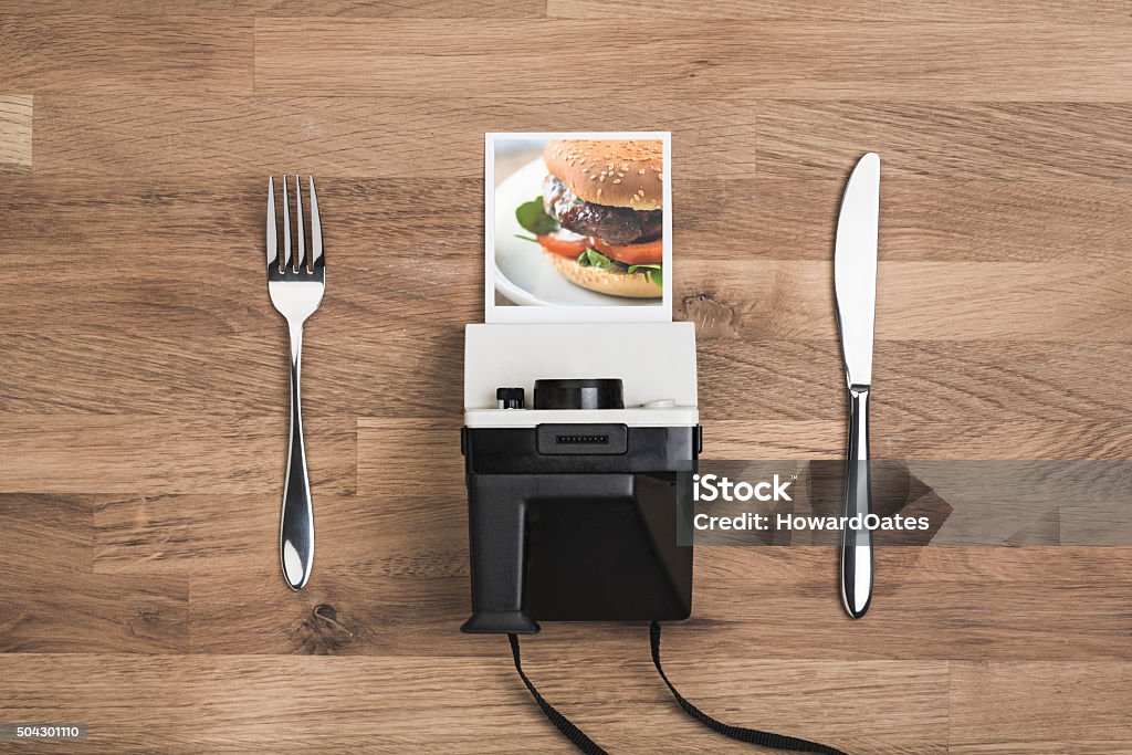 Food photography concept with vintage polaroid camera Food photography concept with vintage polaroid camera and organic burger image Instant Camera Stock Photo
