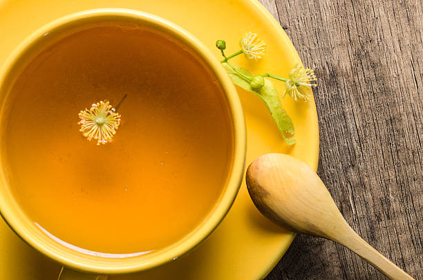 istock Yellow cup with linden tea on the table 504301434