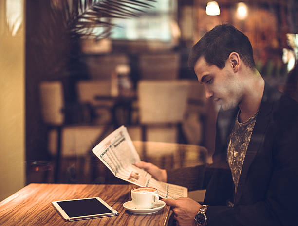 istock young businessman reading a newspaper 504303696