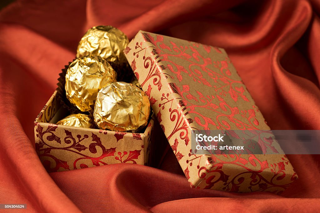 Floral gift box of chocolates. Valentines day, birthday, celebration background. Floral gift box of chocolates. Red Valentines day, birthday or celebration background. Backgrounds Stock Photo