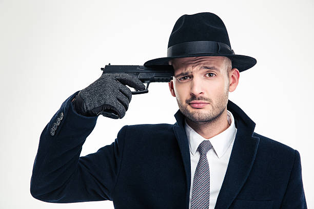 istock Despaired man in hat put gun to his temple 504306066